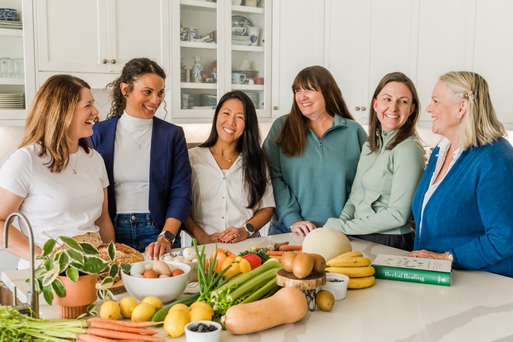 Doris is around the island in a kitchen talking to a group of woman about ways to eat healthy.