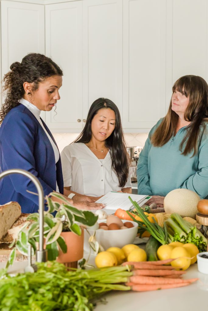 Doris is showing two member a book of recipes to try new dinner ideas.